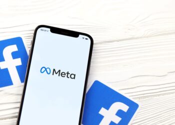 Phone showing Meta logo and facebook logos