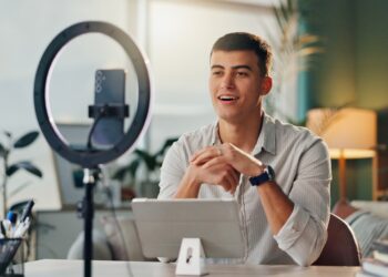 Man talking to phone in front of ring light