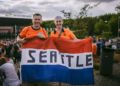 Netherlands fans at the World Cup holding a seattle flag